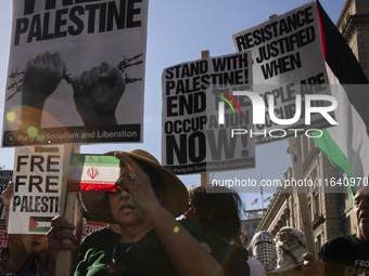 A person shows an Iranian flag during a pro-Palestinian rally as part of an international day of action near the White House in Washington D...