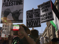 A person shows an Iranian flag during a pro-Palestinian rally as part of an international day of action near the White House in Washington D...