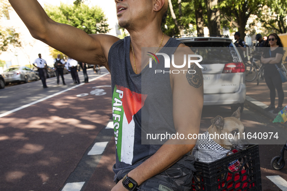 A man and his dog appear during a pro-Palestinian rally as part of an international day of action near the White House in Washington DC, USA...