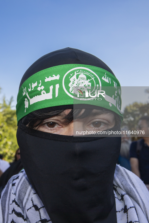 A person poses for photographs during a pro-Palestinian rally as part of an international day of action near the White House in Washington D...