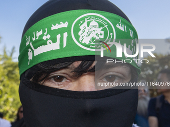 A person poses for photographs during a pro-Palestinian rally as part of an international day of action near the White House in Washington D...