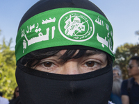 A person poses for photographs during a pro-Palestinian rally as part of an international day of action near the White House in Washington D...