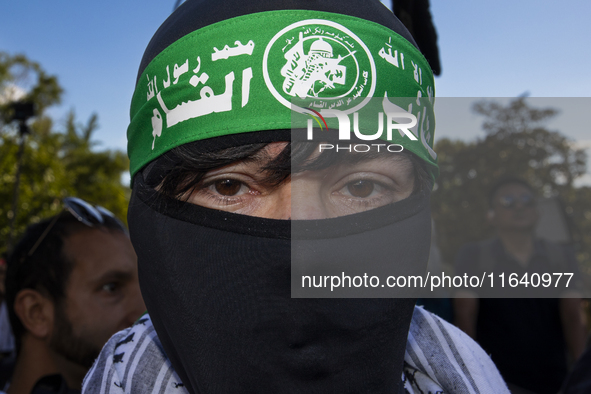 A person poses for photographs during a pro-Palestinian rally as part of an international day of action near the White House in Washington D...