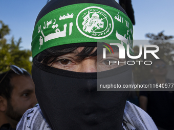 A person poses for photographs during a pro-Palestinian rally as part of an international day of action near the White House in Washington D...