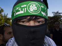 A person poses for photographs during a pro-Palestinian rally as part of an international day of action near the White House in Washington D...