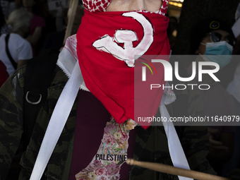 A person poses for photographs during a pro-Palestinian rally as part of an international day of action near the White House in Washington D...