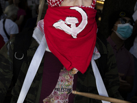 A person poses for photographs during a pro-Palestinian rally as part of an international day of action near the White House in Washington D...