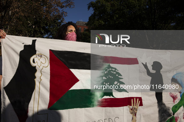 A person poses for photographs during a pro-Palestinian rally as part of an international day of action near the White House in Washington D...