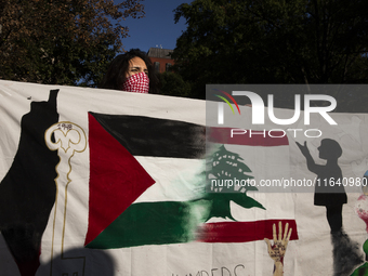 A person poses for photographs during a pro-Palestinian rally as part of an international day of action near the White House in Washington D...