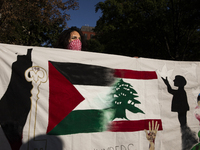 A person poses for photographs during a pro-Palestinian rally as part of an international day of action near the White House in Washington D...