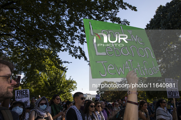 A person holds a sign with the text ''Long Live Lebanon Jew 4 Intifada'' during a pro-Palestinian rally as part of an international day of a...