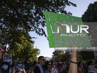 A person holds a sign with the text ''Long Live Lebanon Jew 4 Intifada'' during a pro-Palestinian rally as part of an international day of a...