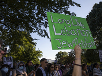 A person holds a sign with the text ''Long Live Lebanon Jew 4 Intifada'' during a pro-Palestinian rally as part of an international day of a...