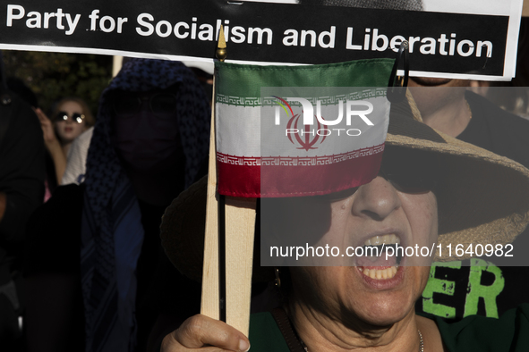 A person shows an Iranian flag during a pro-Palestinian rally as part of an international day of action near the White House in Washington D...