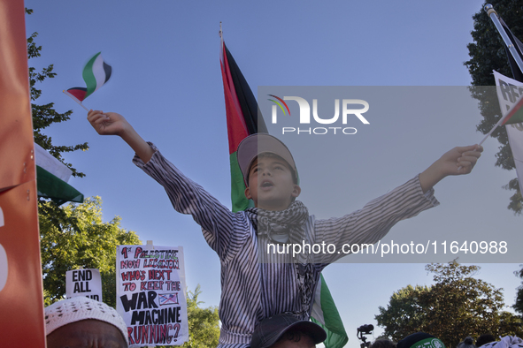 A boy chants and shows Palestinian flags during a pro-Palestinian rally as part of an international day of action near the White House in Wa...