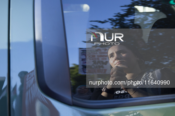 A demonstrator appears in a mirror reflection during a pro-Palestinian rally as part of an international day of action near the White House...