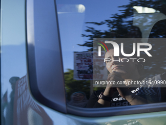 A demonstrator appears in a mirror reflection during a pro-Palestinian rally as part of an international day of action near the White House...