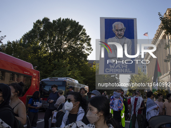 A large picture of Israeli Prime Minister Benjamin Netanyahu displays the text ''War Criminal'' during a pro-Palestinian rally as part of an...