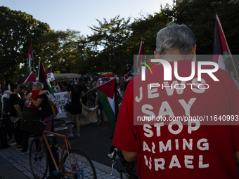 A person wears a red shirt with the text ''Jews Say Stop Arming Israel'' during a pro-Palestinian rally as part of an international day of a...