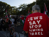 A person wears a red shirt with the text ''Jews Say Stop Arming Israel'' during a pro-Palestinian rally as part of an international day of a...