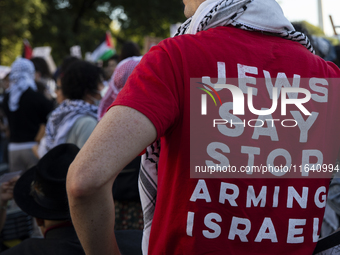 A person wears a red shirt with the text ''Jews Say Stop Arming Israel'' during a pro-Palestinian rally as part of an international day of a...