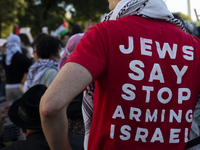 A person wears a red shirt with the text ''Jews Say Stop Arming Israel'' during a pro-Palestinian rally as part of an international day of a...