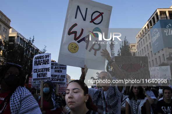 A person holds a sign with the text ''No war'' during a pro-Palestinian rally as part of an international day of action near the White House...