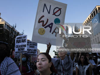 A person holds a sign with the text ''No war'' during a pro-Palestinian rally as part of an international day of action near the White House...