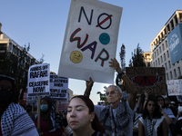 A person holds a sign with the text ''No war'' during a pro-Palestinian rally as part of an international day of action near the White House...