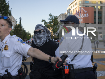 A demonstrator is arrested by police during a pro-Palestinian rally as part of an international day of action near the White House in Washin...