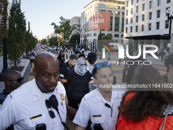 A demonstrator is arrested by police during a pro-Palestinian rally as part of an international day of action near the White House in Washin...