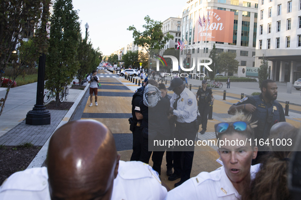 A demonstrator is arrested by police during a pro-Palestinian rally as part of an international day of action near the White House in Washin...