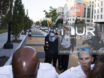 A demonstrator is arrested by police during a pro-Palestinian rally as part of an international day of action near the White House in Washin...