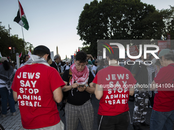 Demonstrators wear red shirts with the text ''Jews Say Stop Arming Israel'' during a pro-Palestinian rally as part of an international day o...