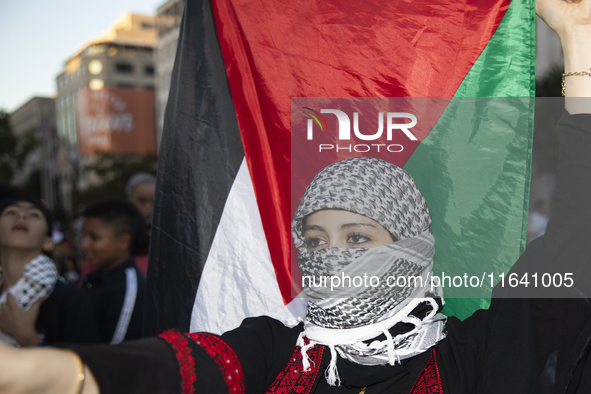 A person poses for photographs during a pro-Palestinian rally as part of an international day of action near the White House in Washington D...