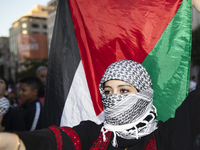 A person poses for photographs during a pro-Palestinian rally as part of an international day of action near the White House in Washington D...