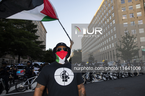 A person poses for photographs during a pro-Palestinian rally as part of an international day of action near the White House in Washington D...