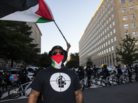 A person poses for photographs during a pro-Palestinian rally as part of an international day of action near the White House in Washington D...