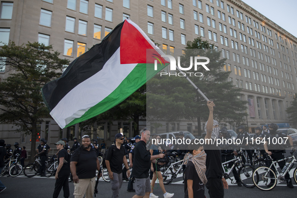 A demonstrator waves a Palestinian flag during a pro-Palestinian rally as part of an international day of action near the White House in Was...