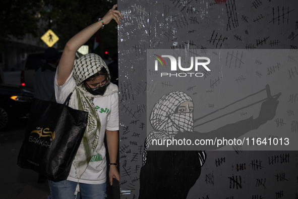 A demonstrator holds the artwork during a pro-Palestinian rally as part of an international day of action near the White House in Washington...