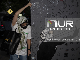 A demonstrator holds the artwork during a pro-Palestinian rally as part of an international day of action near the White House in Washington...