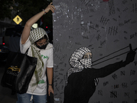 A demonstrator holds the artwork during a pro-Palestinian rally as part of an international day of action near the White House in Washington...