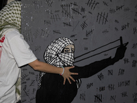 A demonstrator holds the artwork during a pro-Palestinian rally as part of an international day of action near the White House in Washington...