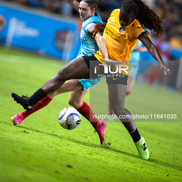 Chicago Red Stars midfielder Taylor Malham (32) and Houston Dash forward Michelle Alozie (11) battle for the ball during a match between Hou...