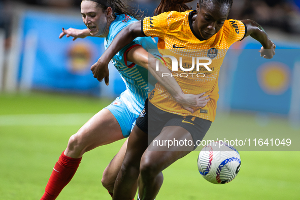 Chicago Red Stars midfielder Taylor Malham (32) and Houston Dash forward Michelle Alozie (11) battle for the ball during a match between Hou...