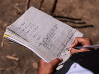 A boy maintains the score during a cricket match played in a paddy field after the harvest in Sopore, Jammu and Kashmir, India, on October 6...