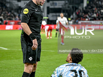 Referee Alex Bos and RKC midfielder Daouda Weidmann are present during the match between Utrecht and RKC at Stadium de Galgenwaard in Utrech...