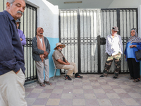 Tunisian voters queue as they await the opening of the polling station to cast their vote during the presidential election in Ariana, a subu...