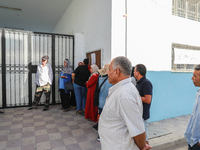 Tunisian voters queue as they await the opening of the polling station to cast their vote during the presidential election in Ariana, a subu...