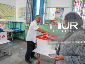 A Tunisian man casts his ballot at a polling station during the presidential election in Ariana, a suburb of Tunis, Tunisia, on October 6, 2...